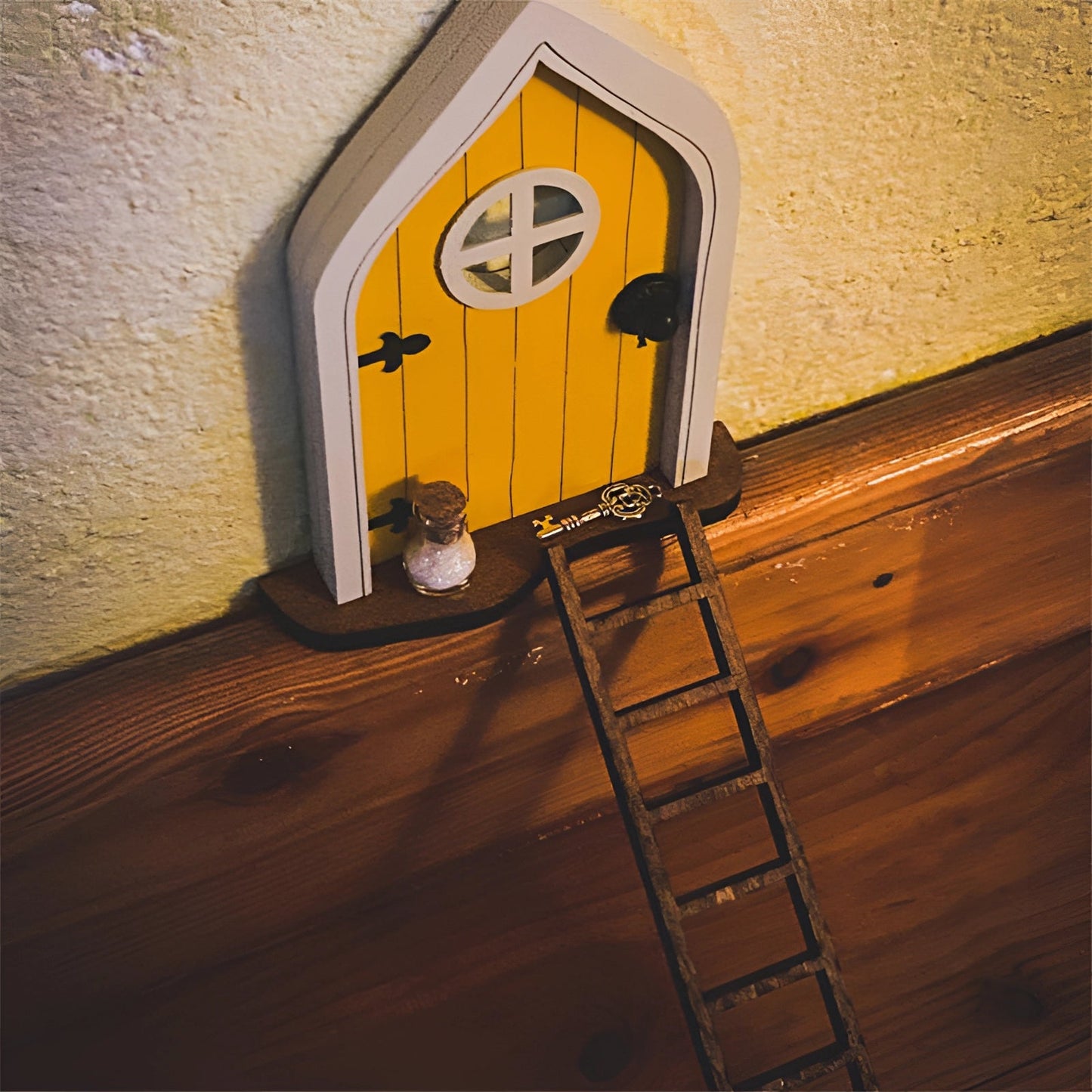 Miniature enchanted tree fairy garden door with intricate wood design featuring amber shades and symmetrical triangular patterns, designed as a whimsical decor accessory.